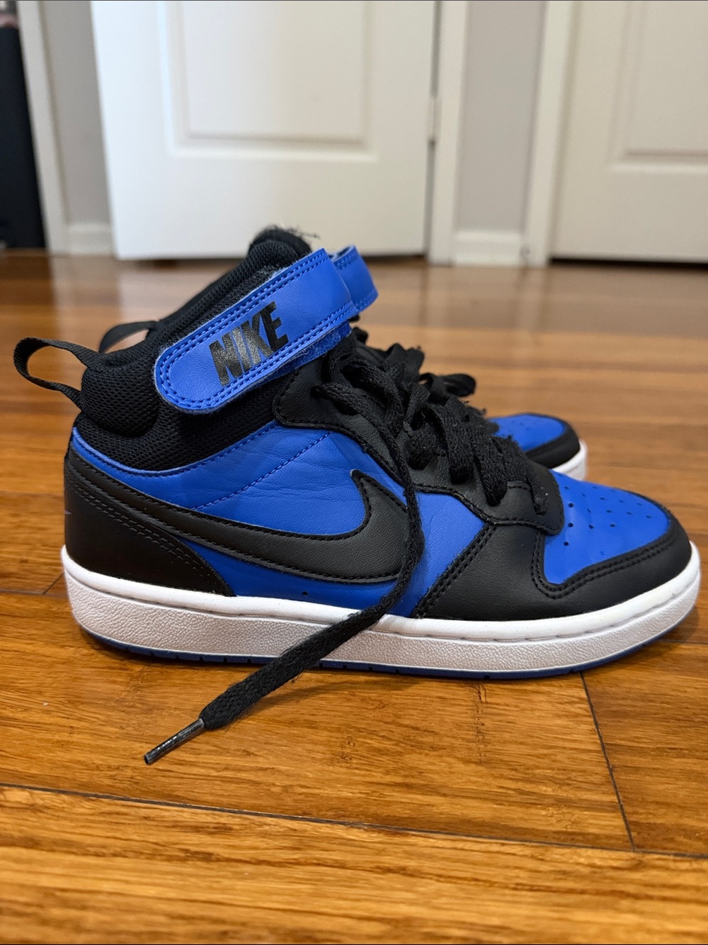 Nike Kids Air Court Borough Mid 2 Sneakers
Size: 4Y Blue and black color